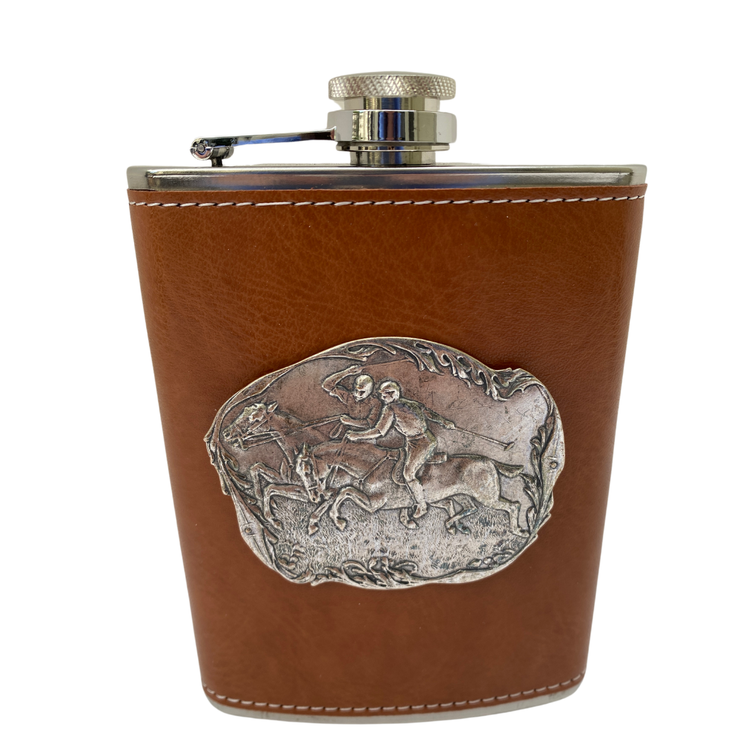 A brown leather flask with a silver polo medallion embossed on it, featuring two polo players and their horses.