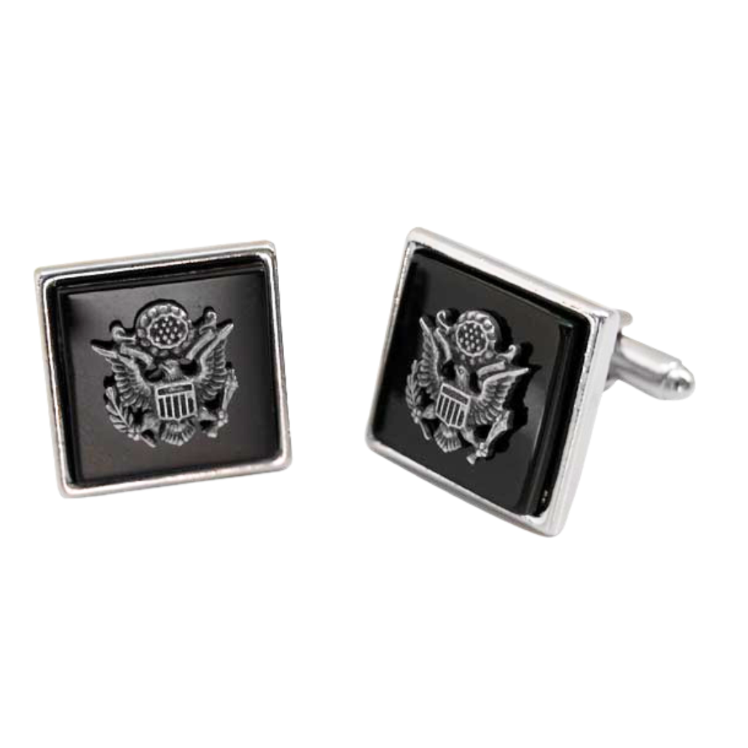 A pair of square black and silver cuff links with a silver USA seal featuring an eagle crest.