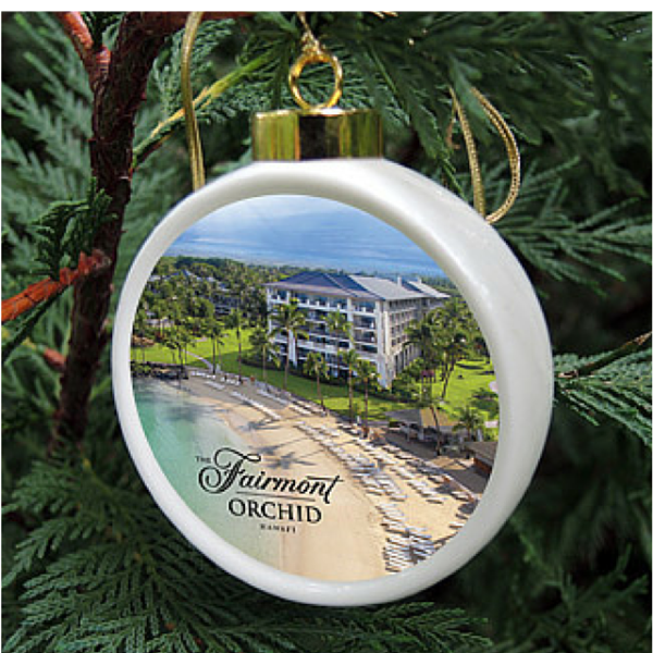The Custom China Christmas ornament is a porcelain drum shape ornament featuring your logo or art. Each is hand-crafted and comes in a gift box with a clear lid. Shown is the design for the Fairmont Orchid in Hawaii.