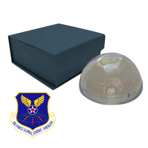 A round glass paperweight with a custom Air Force-themed logo on a blue fabric-lined box with a connected lid.