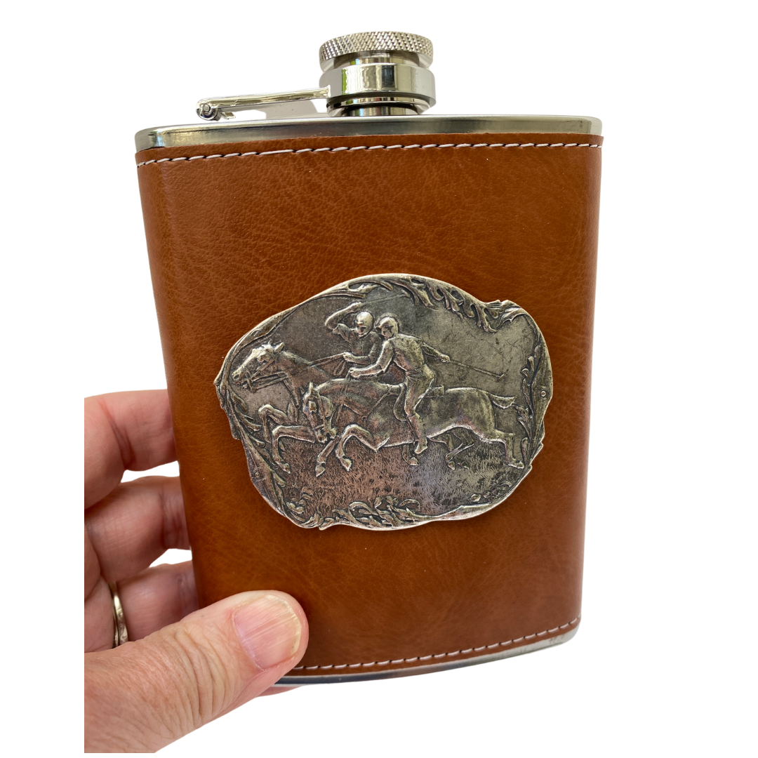 Holding brown leather flask with polo medallion