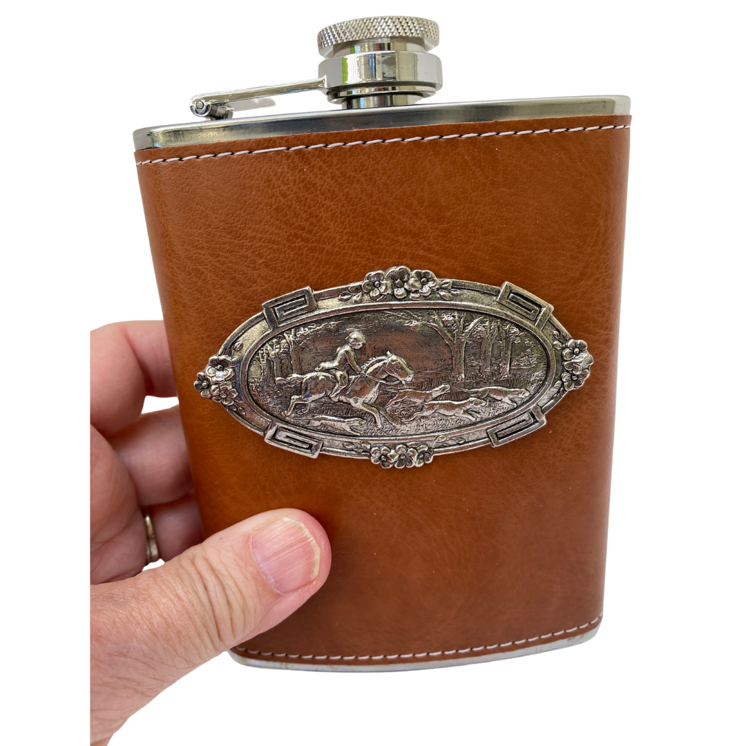 holding leather flask that is embellished with silver medallion featuring horse and hounds