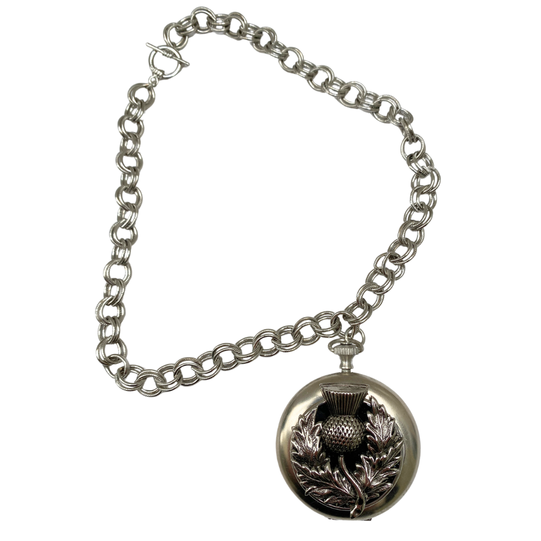 Necklace featuring silver thistle on a vintage pocket watch case full view showing silver chain