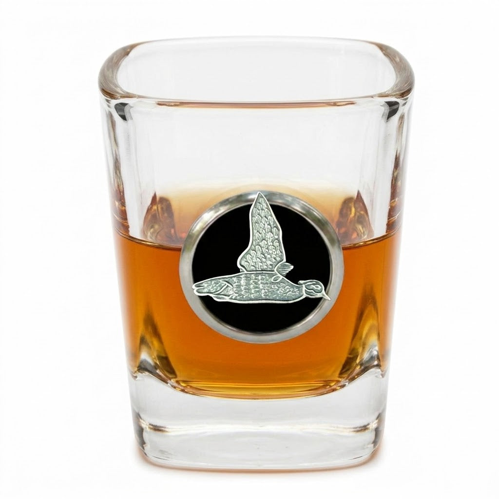 Shot glass featuring a silver medallion with black enamel and a silver duck. This is a great gift for a duck hunter or duck lover.