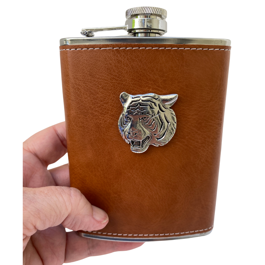 holding brown leather flask with silver tiger head medallion