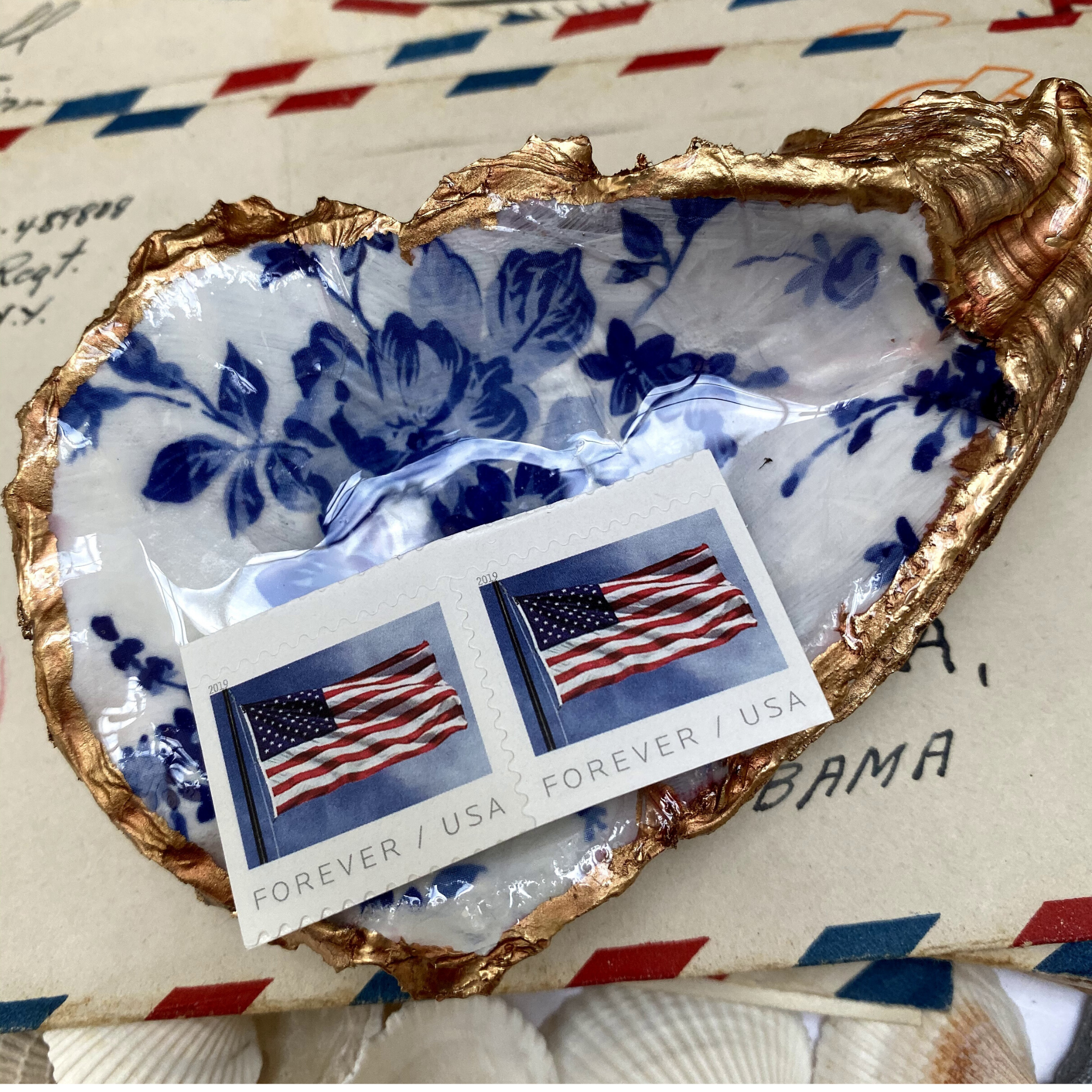 oyster shell art with blue and white flowers