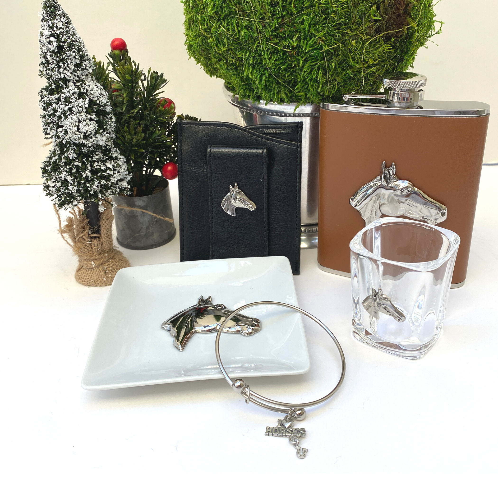 A luxury gift box for horse lovers, featuring a brown leather flask, shot glass, trinket tray, faux leather money clip, and a bracelet with a horse charm.