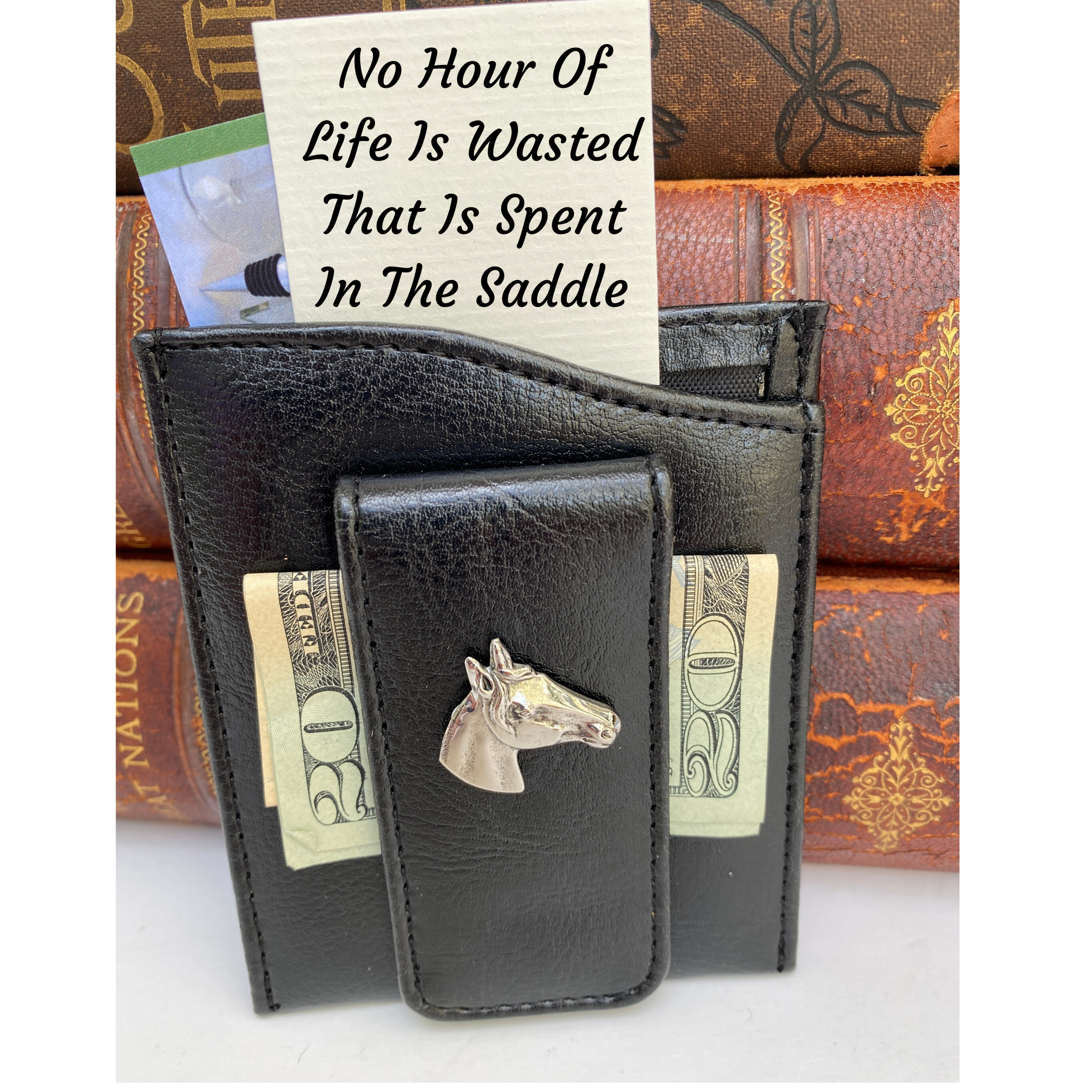 Black faux leather money clip with silver horse head. It holds business cards, credit cards, and cash. Great gift for horse lover. Note with quote sticking out.