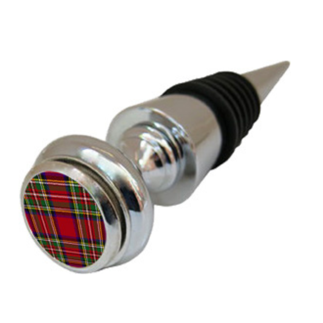 A silver wine bottle stopper with a round red plaid design medallion.