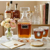 The Classic Legacy "Congrats"  decanter features an elegant bourbon marker with the word "Congrats".  The set also includes two bourbon glasses that are embellished with silver medallions.