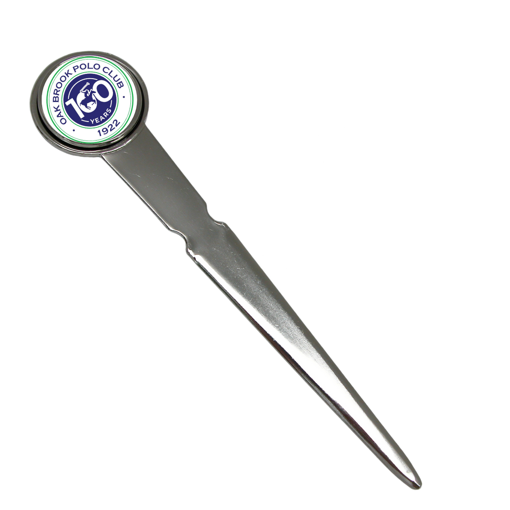 A custom silver letter opener with a round head featuring a logo or art, positioned on a plain background.
