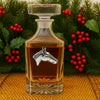 Horse head decanter with Christmas greenery and berries in the background