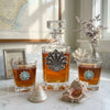 Our fancy shell decanter set features a large decanter and two bourbon glasses.  Each is embellished with vintage inspired seashells.