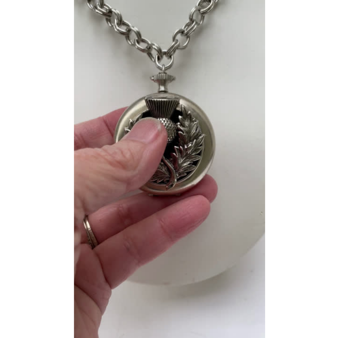 Holding vintage pocket watch necklace