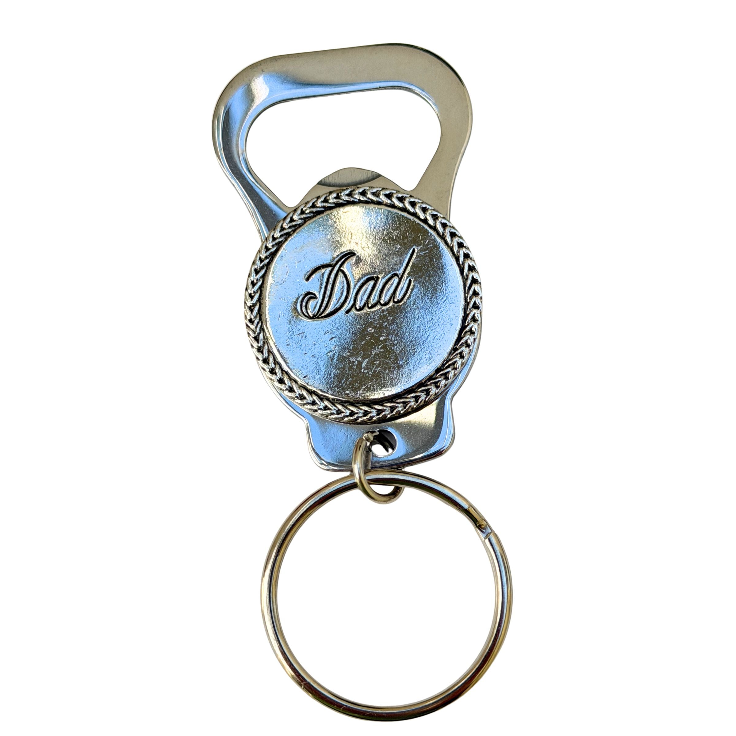 Metallic bottle opener keychain with 'Dad' engraving on a white background