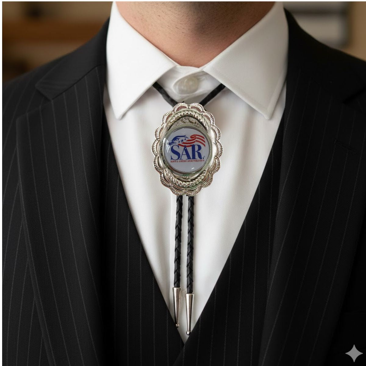 Classic Legacy bolo ties feature a large silver medallion and YOUR logo in the center.  This is a great option to feature your organization.  It is a wonderful accessory to wear to a Western-themed wedding or event.   This photo shows a man wearing the custom SAR logo bolo tie