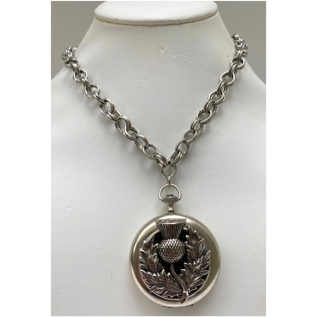 Necklace featuring silver thistle on a vintage pocket watch case