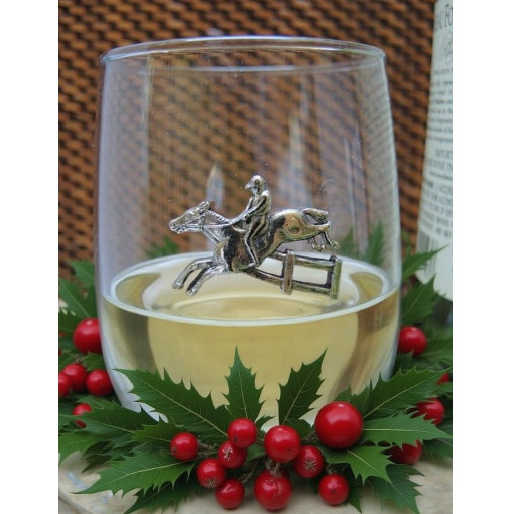Clear glass with a silver horse and rider charm, surrounded by holly leaves and berries.