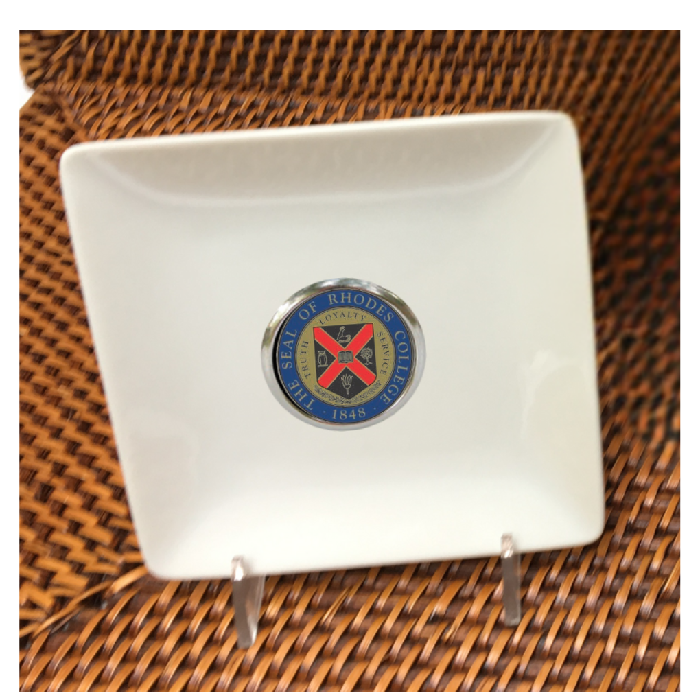 Our custom trinket trays are personalized with a round silver setting that features your logo, art, or photo. MINIMUM ORDER QUANTITIES APPLY.  These trinket dishes are 4.5" square and can be used to hold earrings, necklaces, bracelets, and also golf tees and coins!  Stand one on an easel for instant art for your bookshelf or desk.