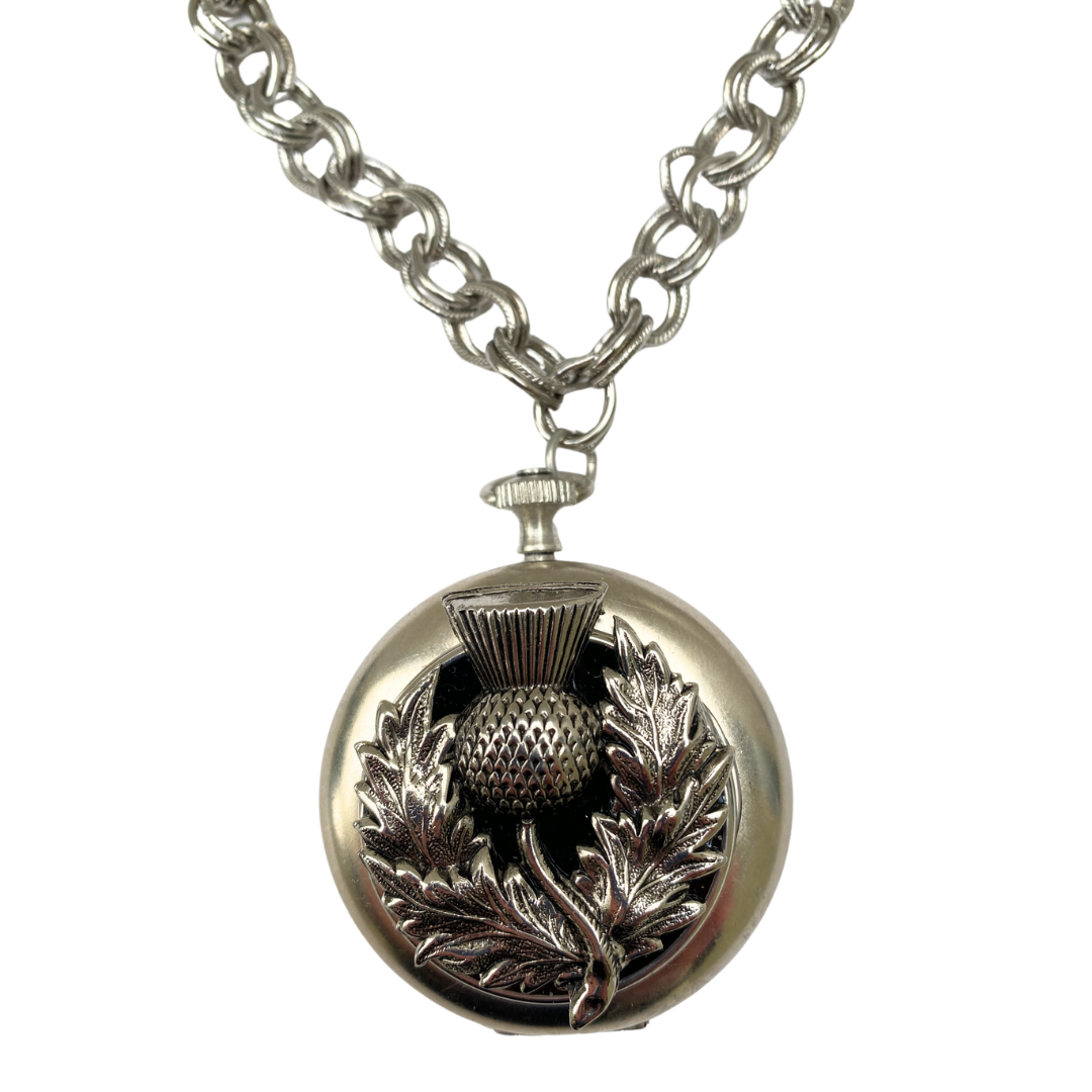 Necklace featuring silver thistle on a vintage pocket watch case Close Up view
