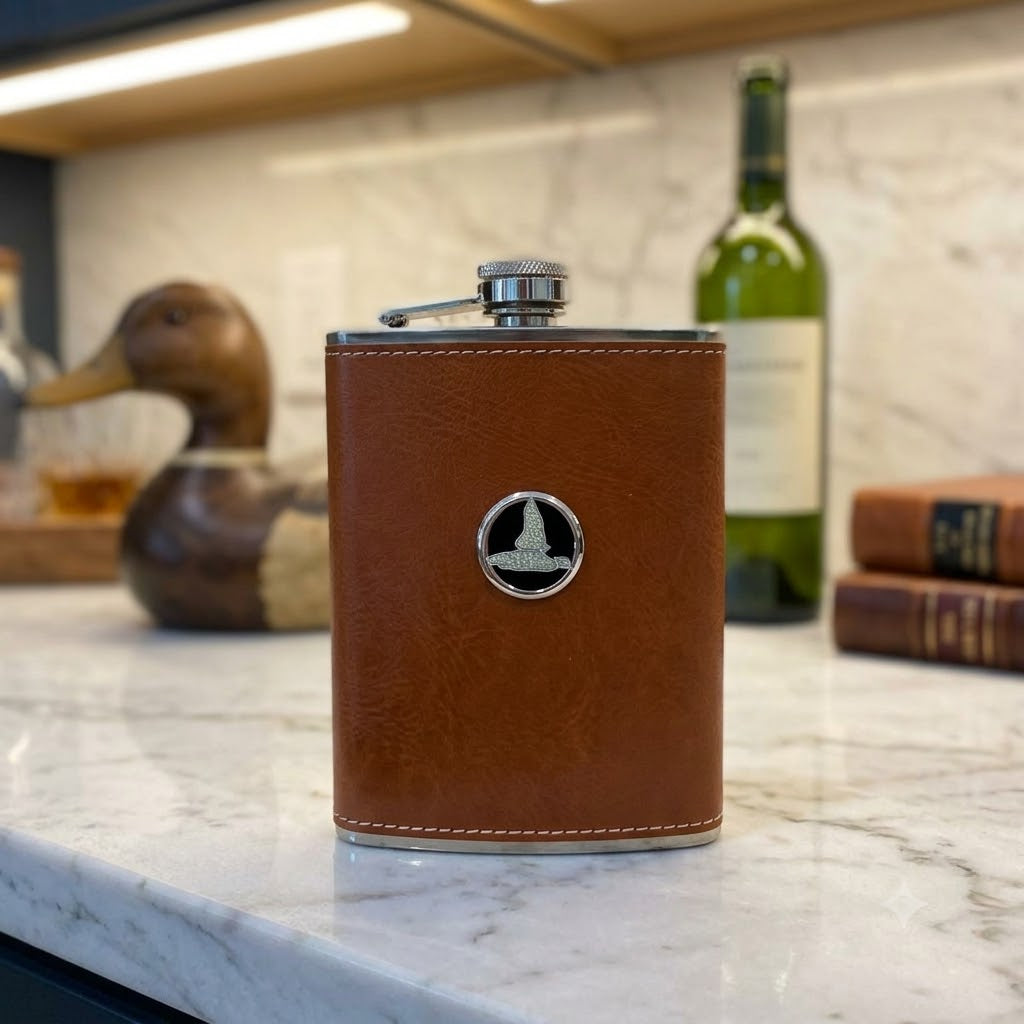 This leather flask features a silver medallion with black enamel and a silver duck.  This is a great gift for a duck hunter and duck lover.