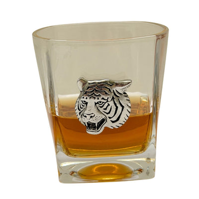 Bourbon glass with silver tiger head turning on home bar setting