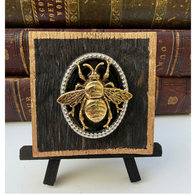 Wooden art with gold bee on black and silver