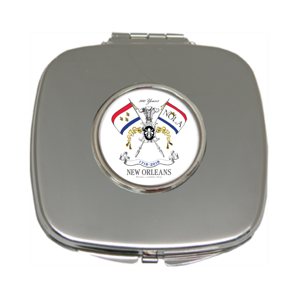The custom purse mirror by Classic Legacy is a silver plate and features your logo inside a silver setting.&nbsp; &nbsp; Open the mirror up, and you will find two mirrors.  One is single magnification, and the other is double magnification.  The mirror comes in a pouch.  This makes a great custom gift.  This is the design for the 300th Anniversary of New Orleans.