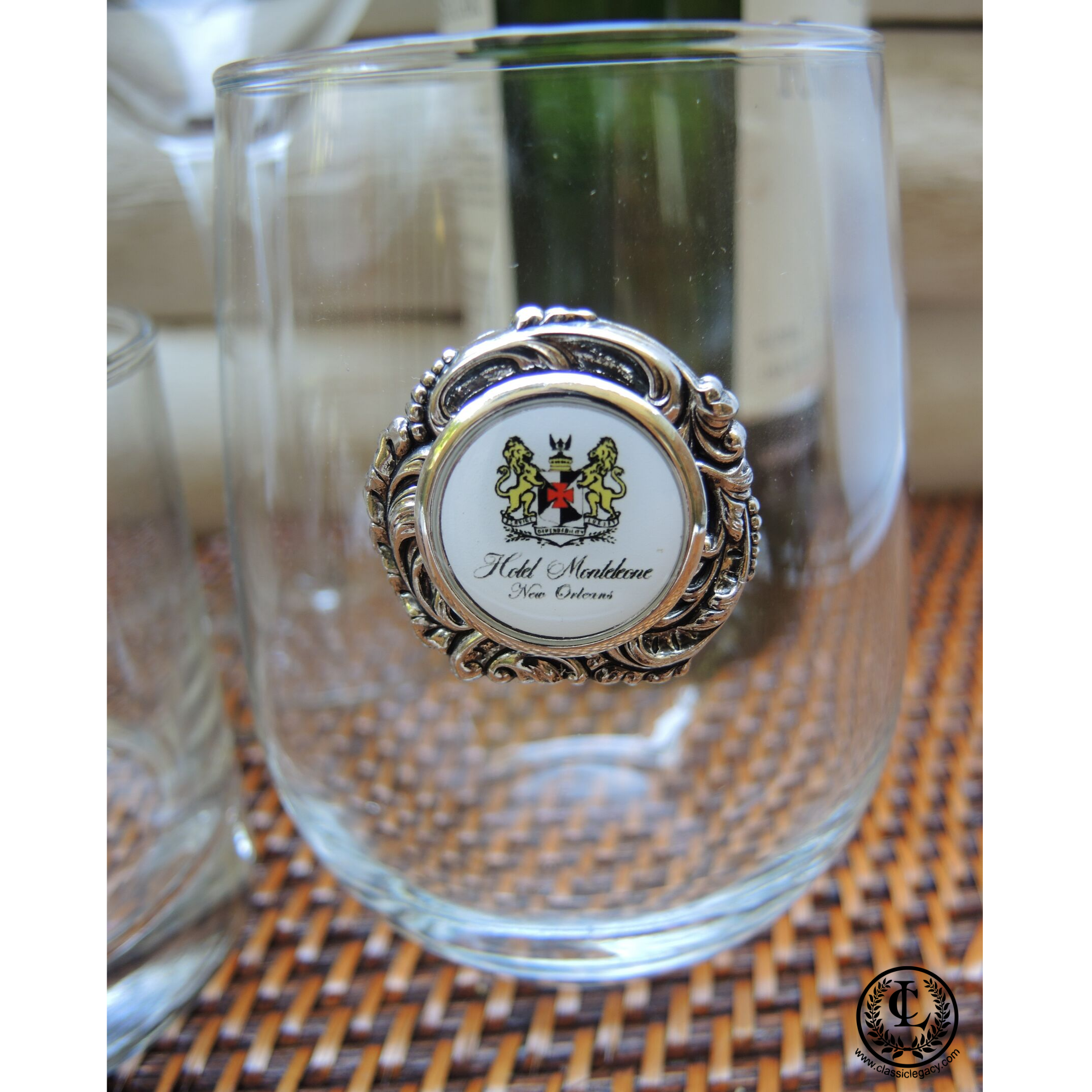 This stemless wine glass is designed to feature YOUR art, logo, or photograph.   Our stemless wine glass holds 17 ounces.  It is embellished with a silver medallion and a setting with YOUR custom logo.    This glass features the logo of The Hotel Monteleone.