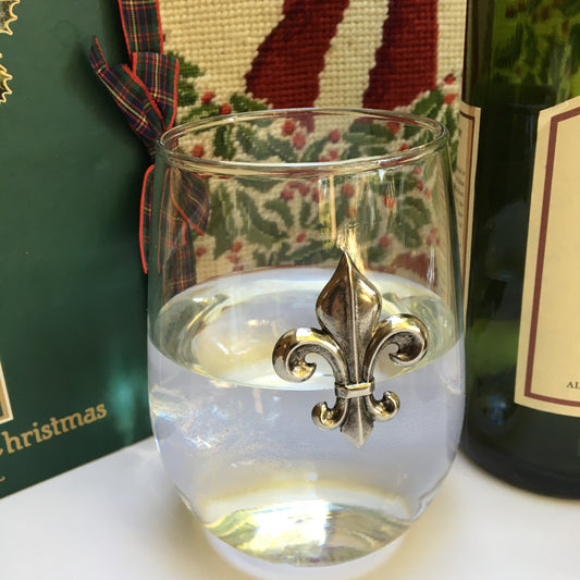 Stemless wine glass with Silver Fleur de Lis medallion. The Classic Legacy stemless wine glass holds 17 ounces of wine. Dimensions are 4.75” x 2.75”. Great table top gift for fleur de lis lovers!  