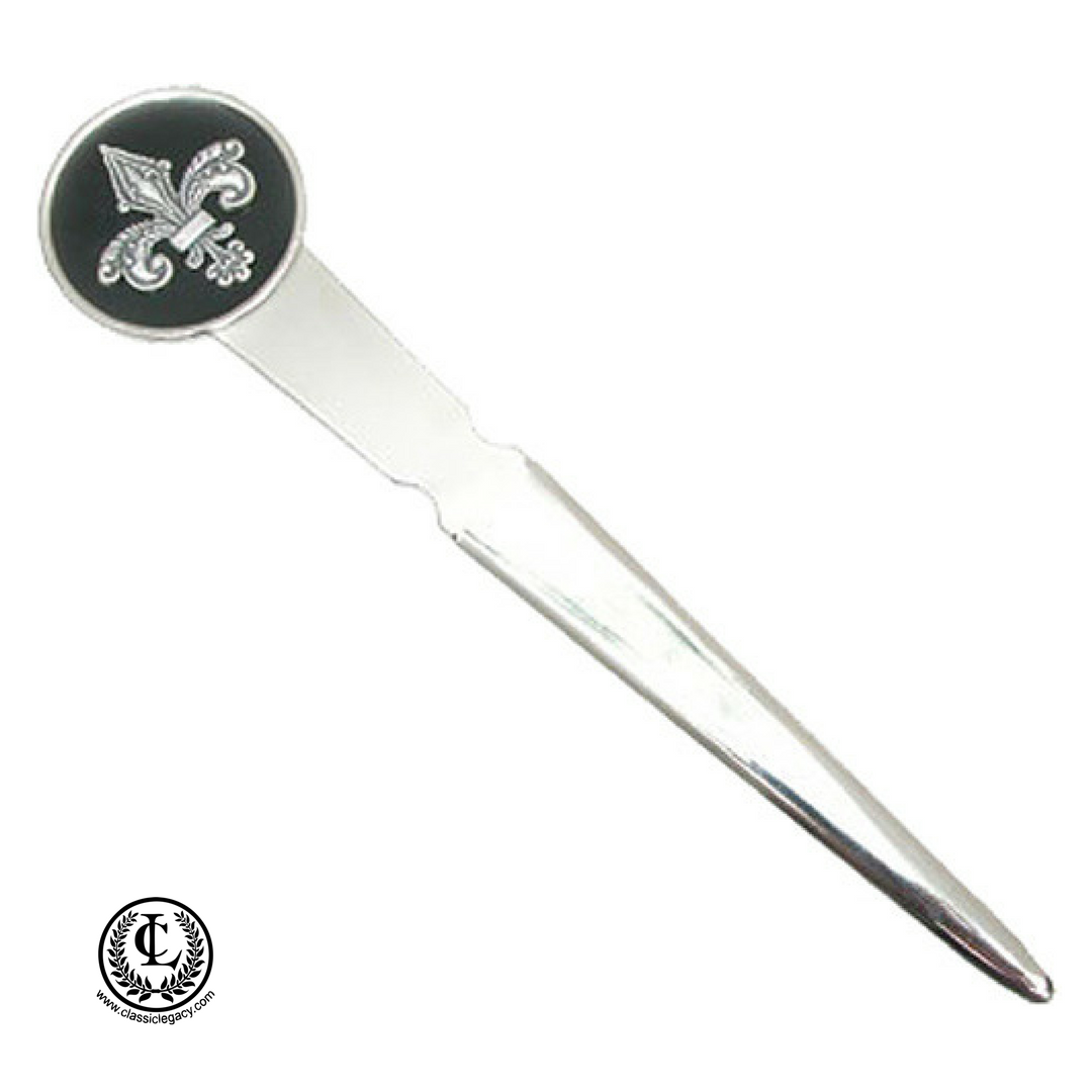 A silver fleur de lis letter opener with a black enamel round setting.