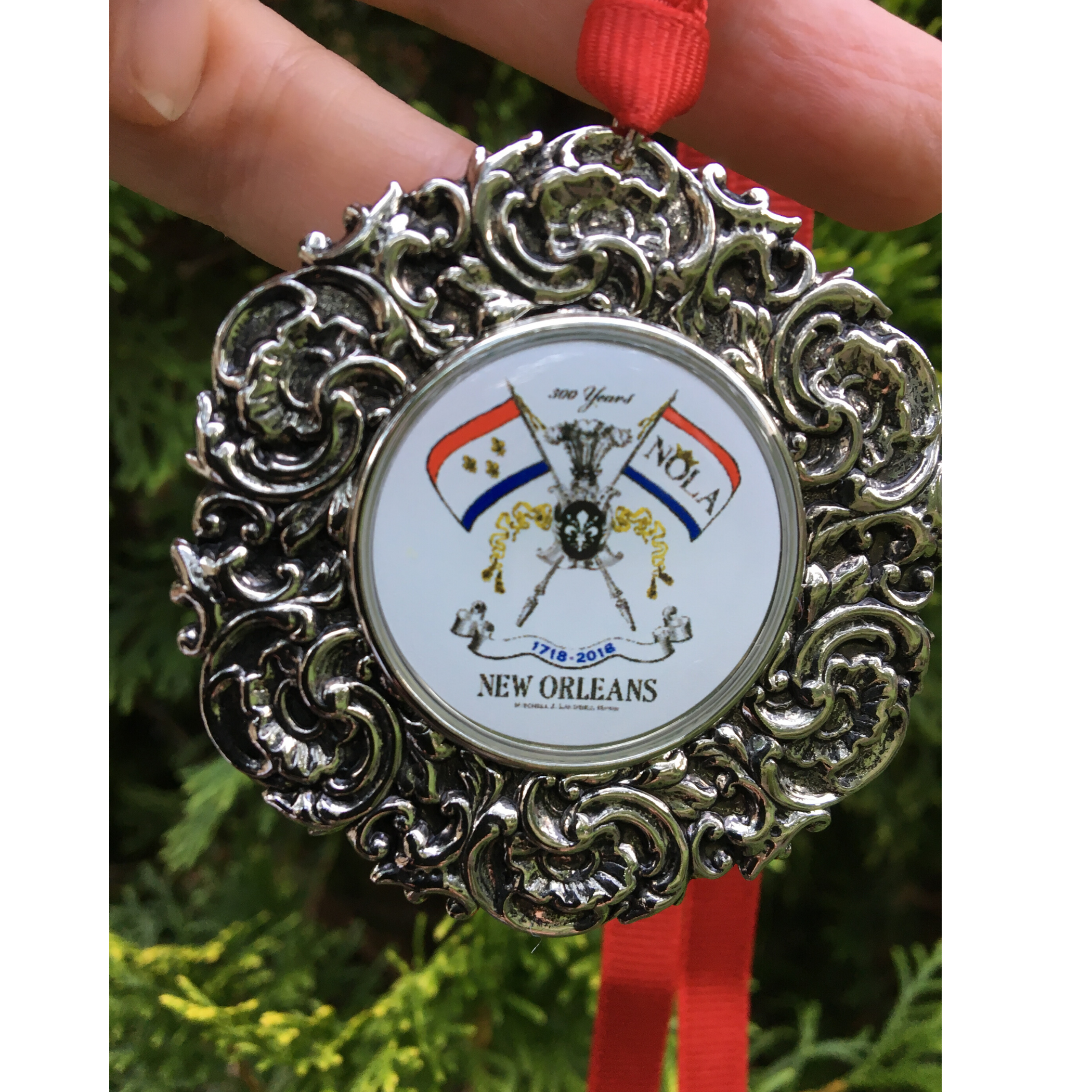 The Custom Christmas Ornament in the Classic Legacy collection is designed with a vintage inspired silver medallion.  In the center is the art of logo.  This is a personalized gift for corporations, hotels, and museums.  Shown is the New Orleans Christmas ornament celebrating 300 years.