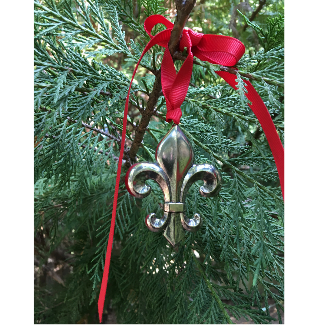 Our fleur de lis Christmas ornament is solid brass and plated in gold, silver, or antique brass.  It is 2.75" long with 24" or red grosgrain ribbon to hang on your tree.   Celebrate all things fleur de lis at Christmas!  