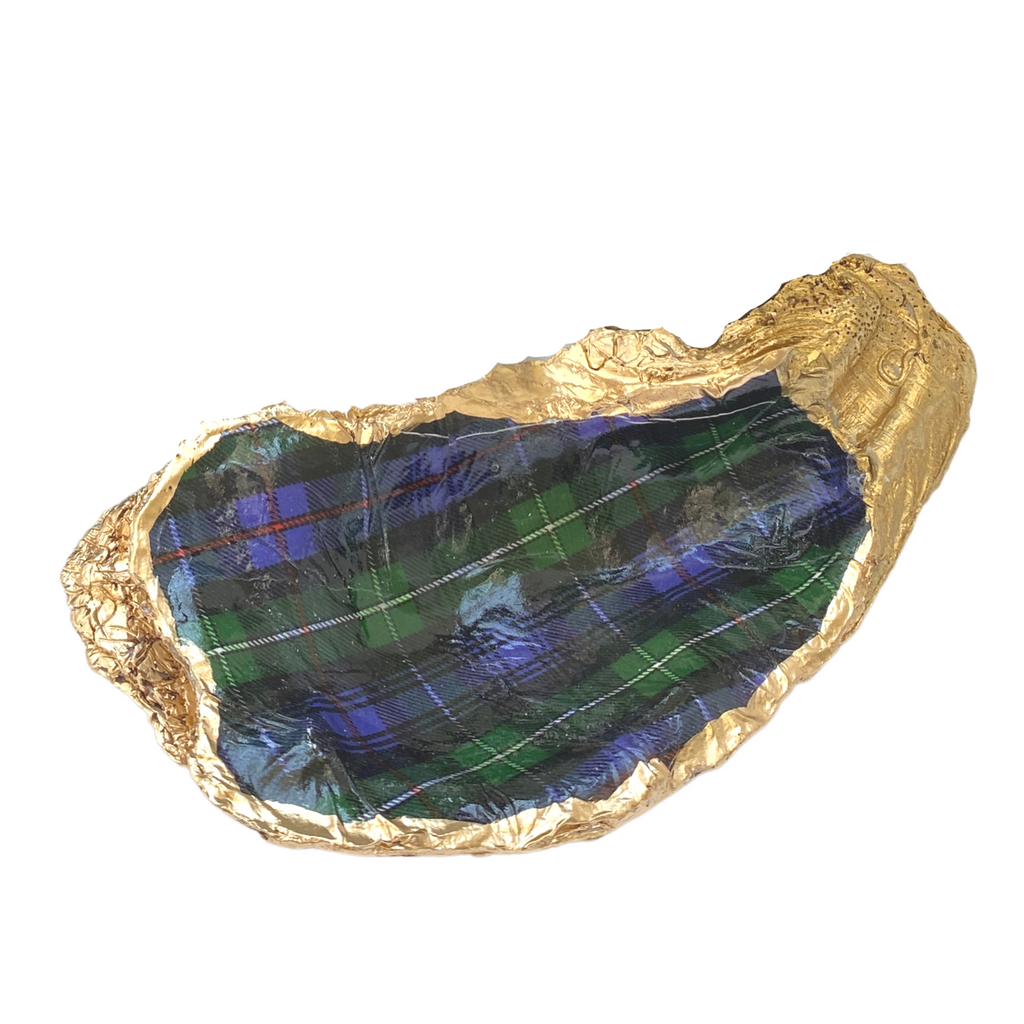 A Scottish tartan plaid oyster shell dish with gold leaf accents on the edges.