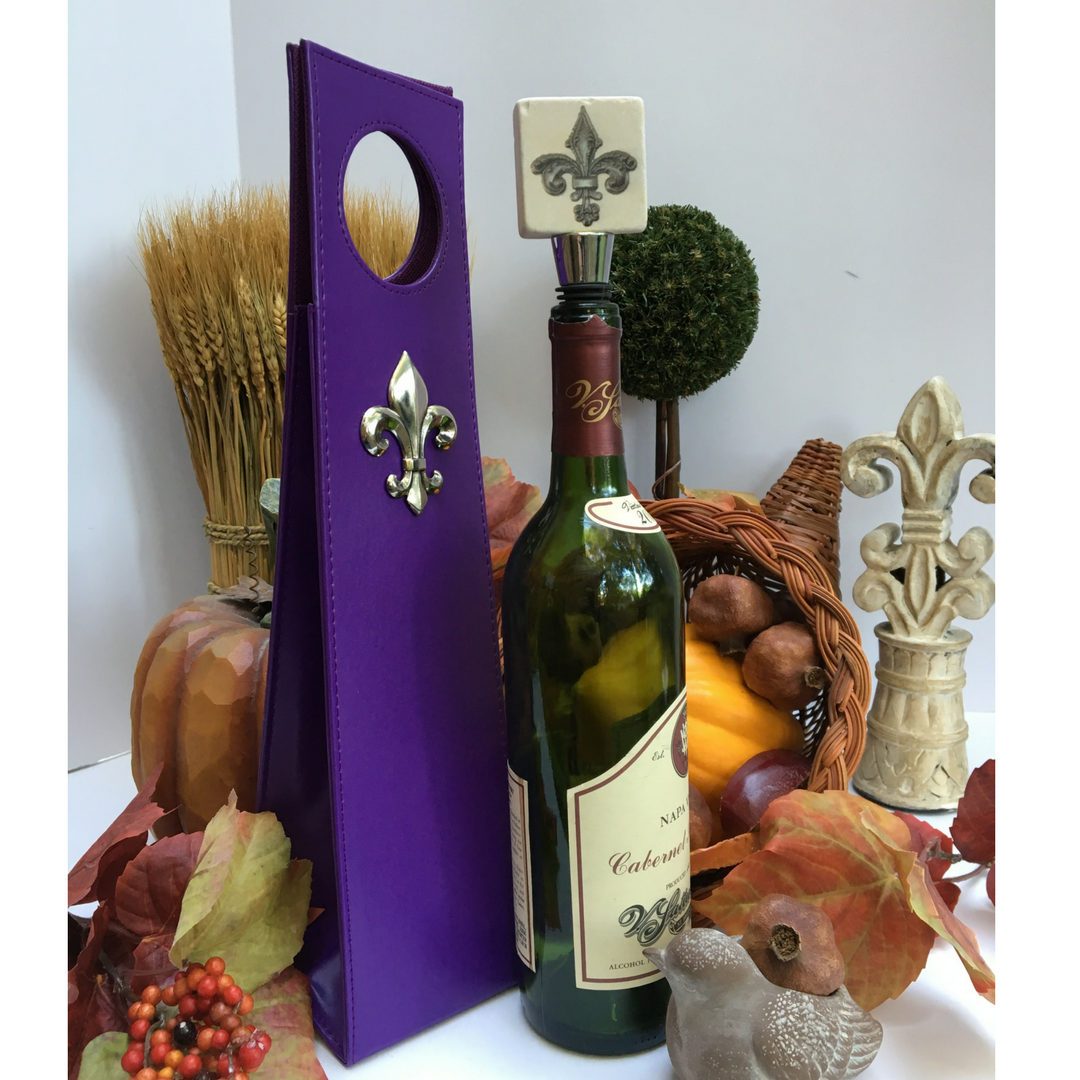 This purple wine carrier is embellished with a large silver Fleur de Lis medallion. The carrier is easy to carry and holds a standard size bottle of wine. It makes a great hostess gift or easy wine transport to a party. When not in use, the carrier collapses for easy storage. The measurements are 3.5" x 15" x 3.5".