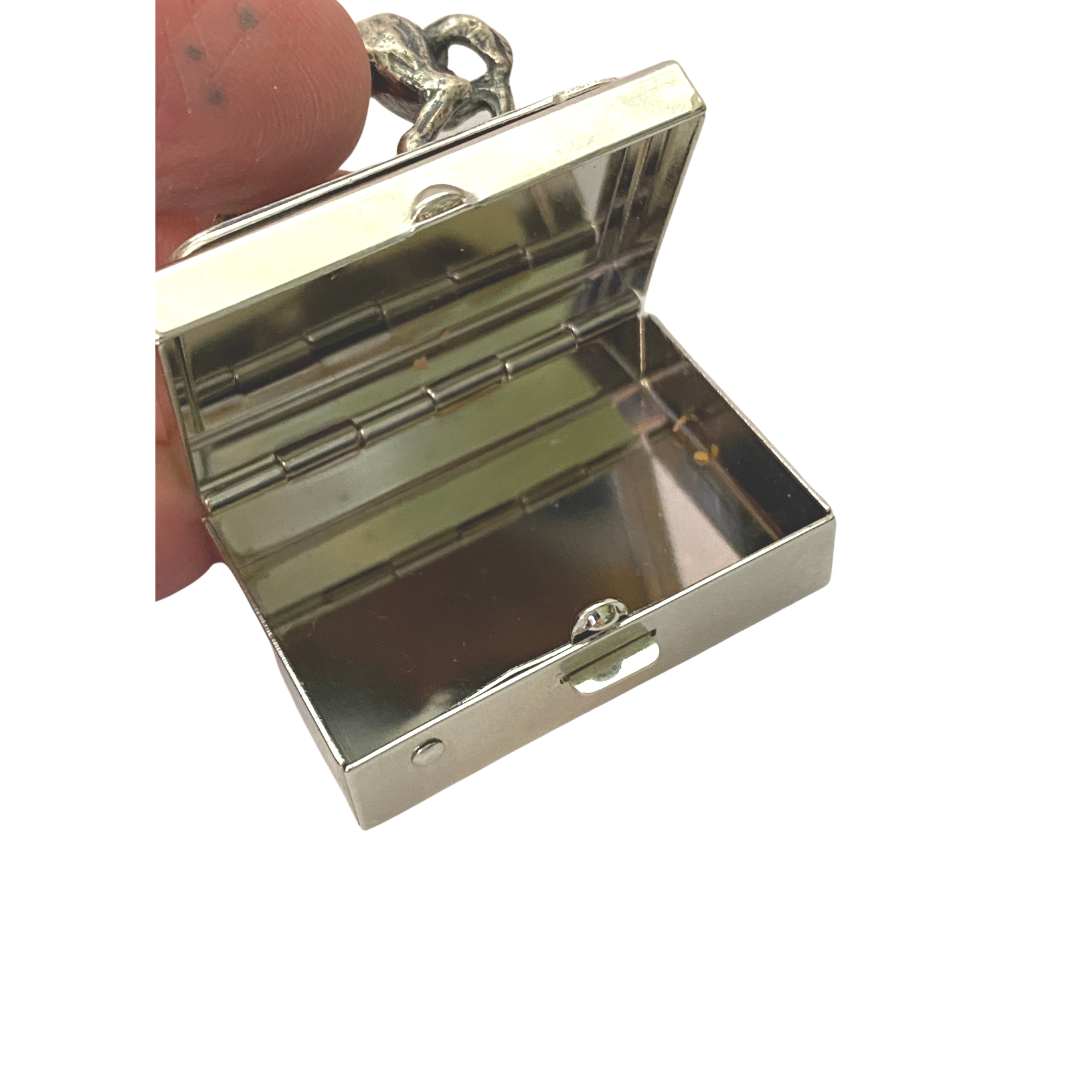 open view of small silver box with racehorse